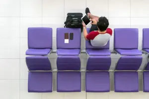 happy-asian-man-traveler-working-with-technology