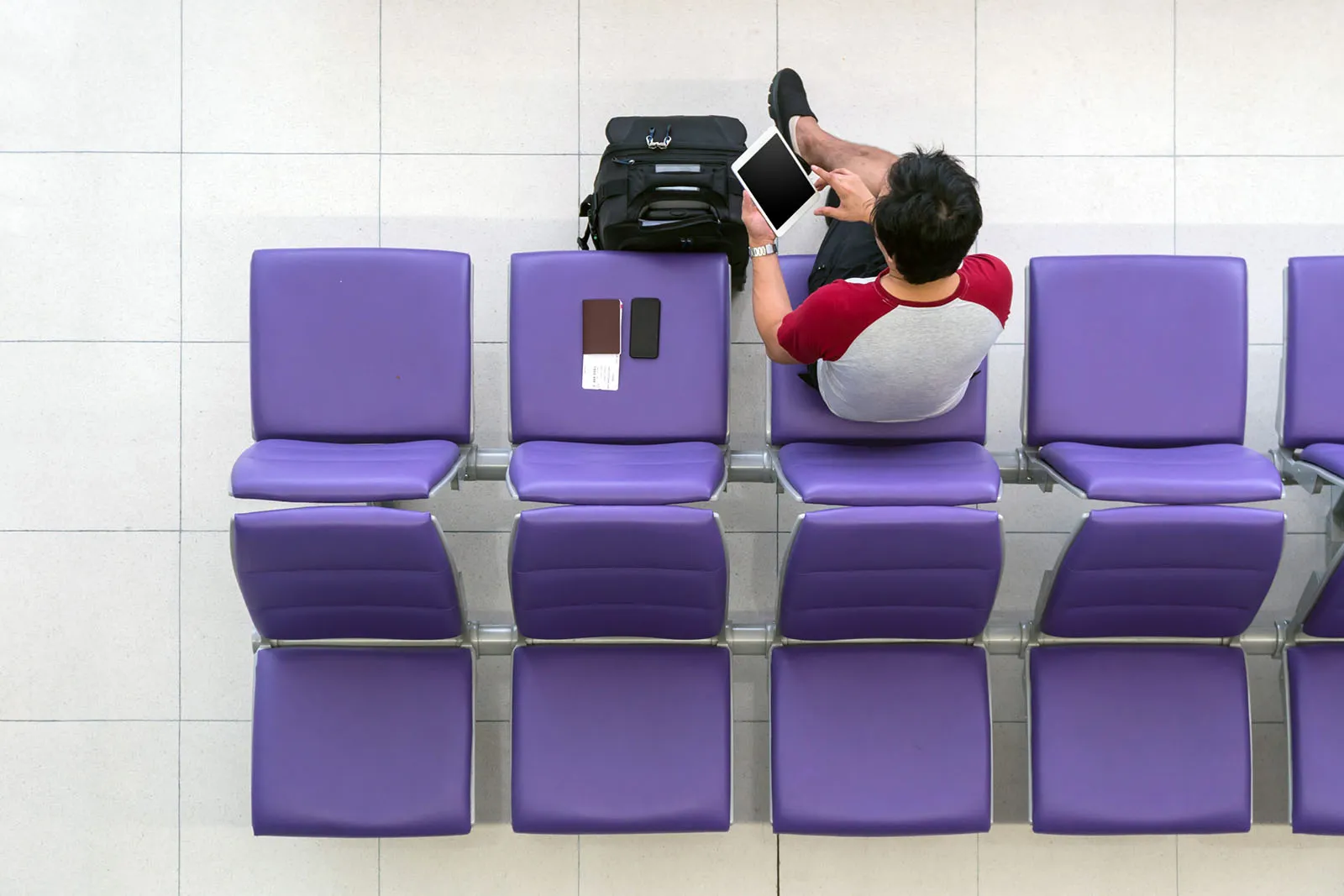 happy-asian-man-traveler-working-with-technology